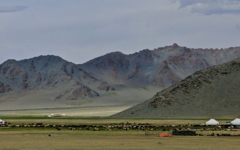 A beautiful shot of the valley of the green mountain and a cloudy sky